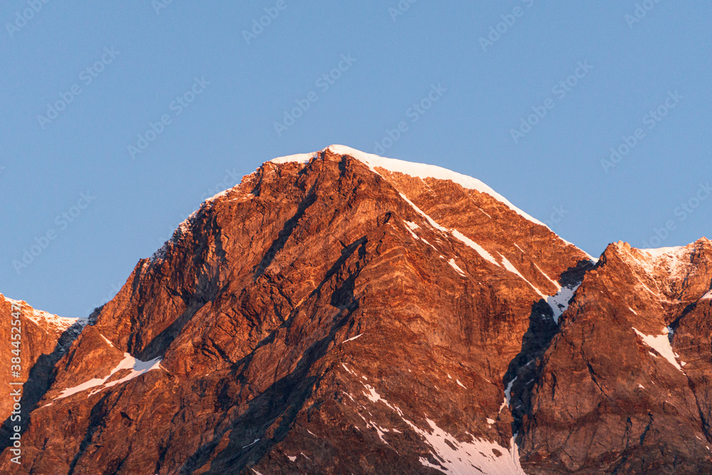 Sunrise on monte rosa and its glaciers, seen from the town of Macugnaga, Italy - July 2020.