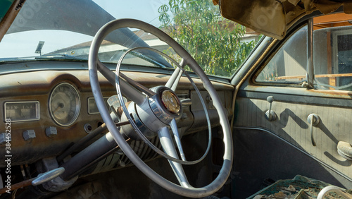 The steering wheel of an old classic car from the 1950's.