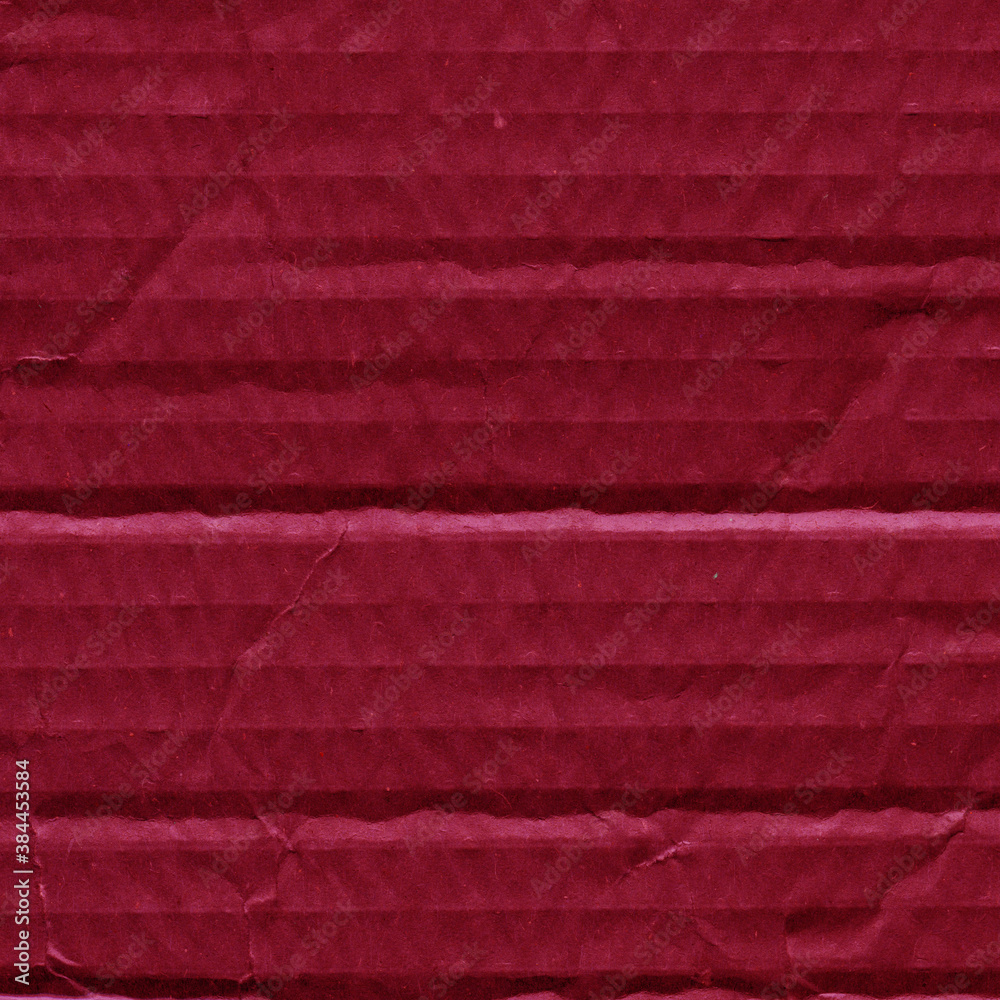 Fototapeta premium A red vintage rough sheet of carton. Recycled environmentally friendly cardboard paper texture. Simple and bright minimalist papercraft background.