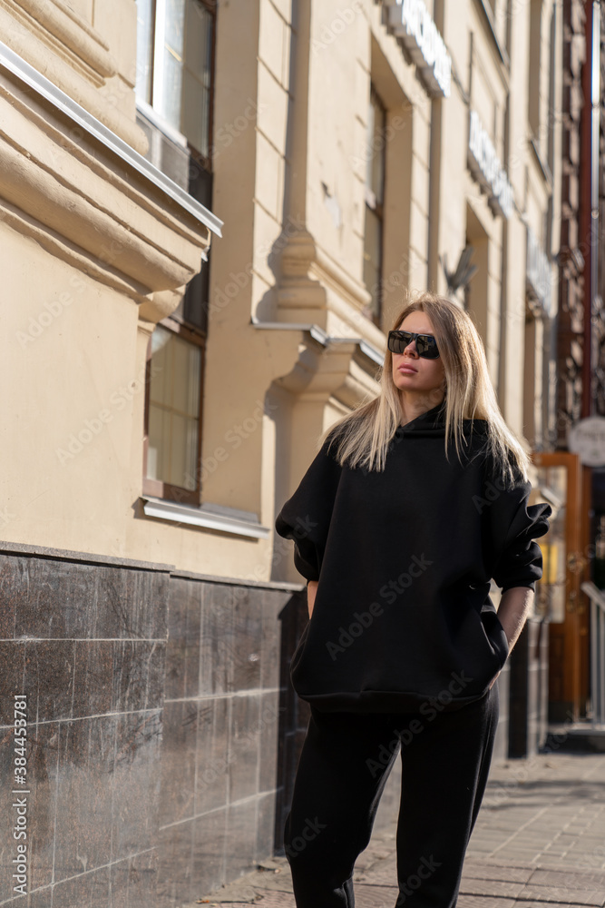 girl in sportswear walking along the city street girl in sportswear walking along the city street