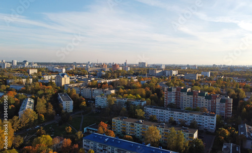 Top view of a beautiful autumn park in the city with houses © Payllik