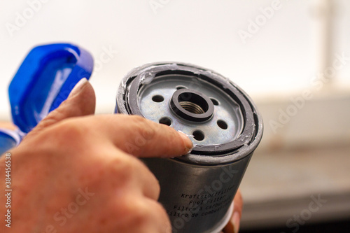Fototapete Greasing the o-ring on a fuel filter