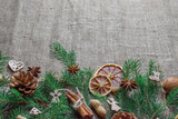 Fabric background with fir branches and spices for mulled wine. Christmas decorations. Happy new year