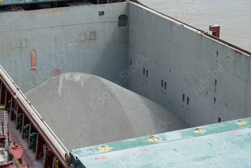 Cargo hold of bulk carrier ship full of bulk cargo bauxite.