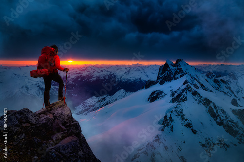 Girl Backpacker on top of a Mountain Peak. Dreamscape Artistic Render Composite. Landscape background from British Columbia, Canada. Dark Dramatic Sunset Sky.
