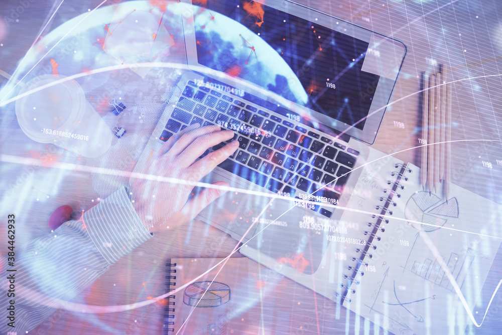 Double exposure of man's hands typing over computer keyboard and forex graph hologram drawing. Top view. Financial markets concept. Double exposure of man's hands typing over computer keyboard and forex graph hologram drawing. Top view. Financial markets concept.