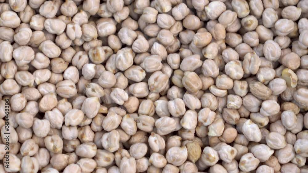 A lot of chickpeas on the market close-up. The camera moves. A lot of chickpeas on the market close-up. The camera moves.