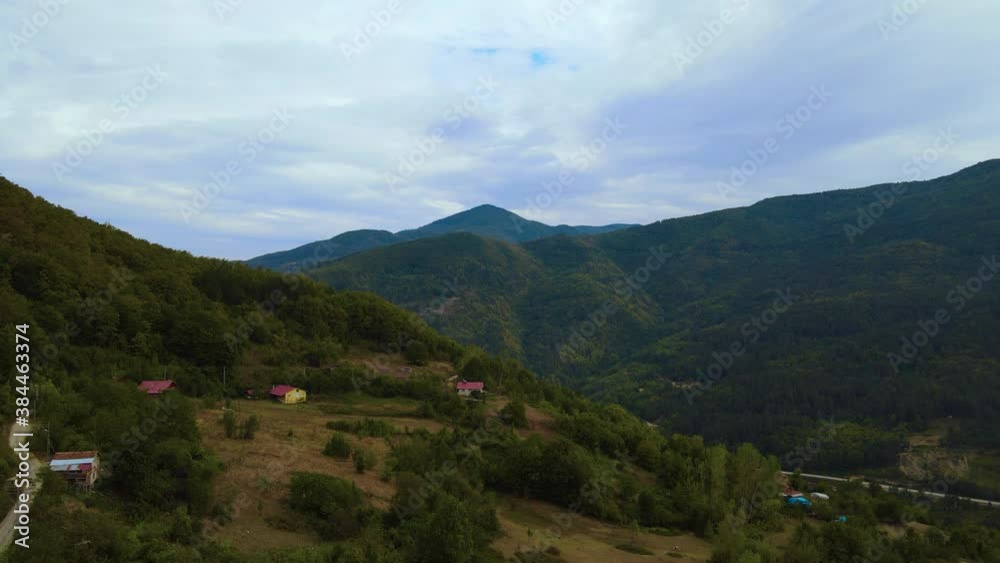 Steep green mountains, deep forest and mountain road, beautiful valley Steep green mountains, deep forest and mountain road, beautiful valley