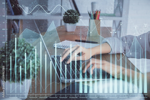 Double exposure of woman hands typing on computer and forex chart hologram drawing. Stock market invest concept.