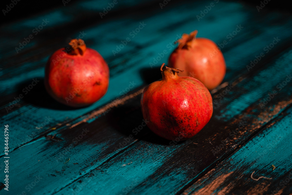 pomegranates on wooden blue table pomegranates on wooden blue table