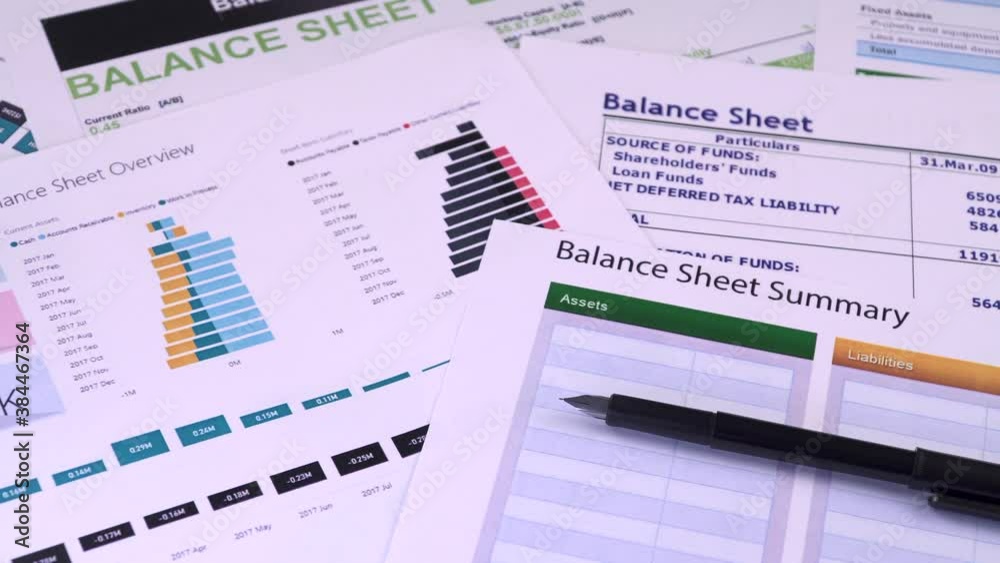 Conceptual composition. Balance sheet summary form and pen on the background of financial documents, close-up Conceptual composition. Balance sheet summary form and pen on the background of financial documents, close-up