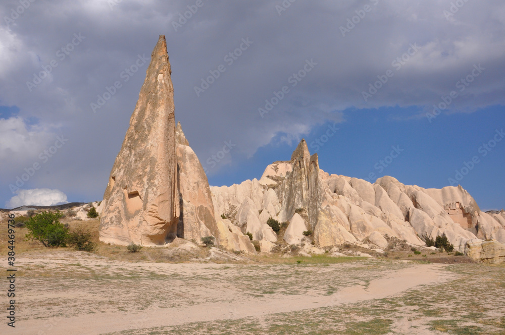 Scenic landscape view of a trail winding through the surreal landscape of Cappadocia, Turkey, on a cloudy day