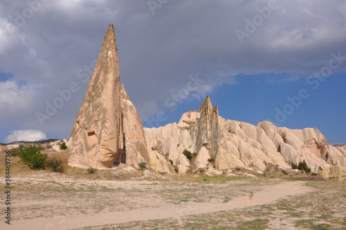 Scenic landscape view of a trail winding through the surreal landscape of Cappadocia, Turkey, on a cloudy day