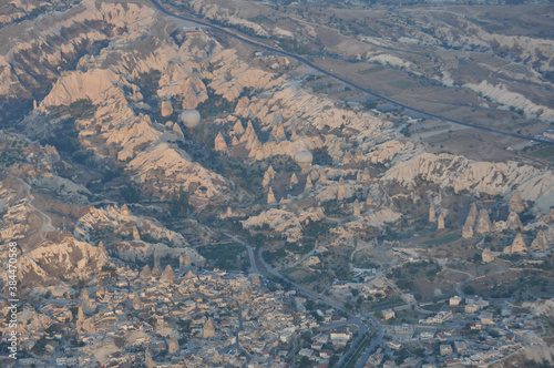 Aerial view of hot air balloons and the surreal landscape of Cappadocia, Turkey, at sunrise © Jen