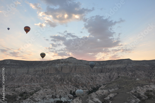 Aerial view of hot air balloons and the surreal landscape of Cappadocia  Turkey  at sunrise