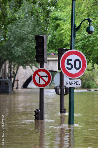 Photography Traffic light and traffic signs standing in a flooded road , Paris France