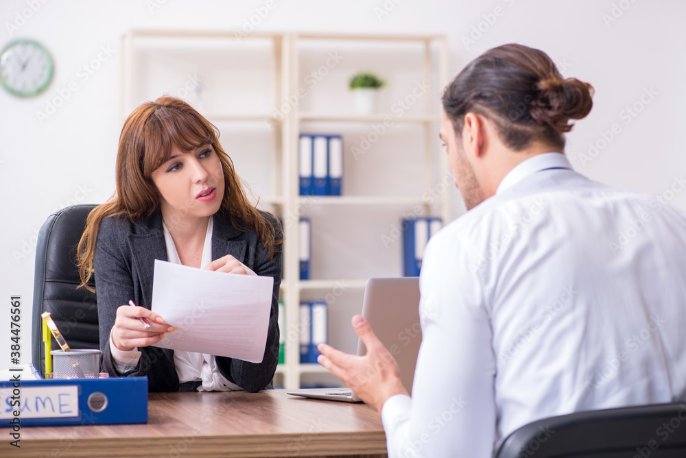 Business meeting between businessman and businesswoman Business meeting between businessman and businesswoman