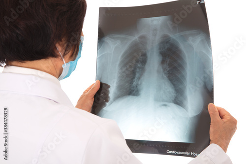Female doctor carefully examines patient's lung X-ray