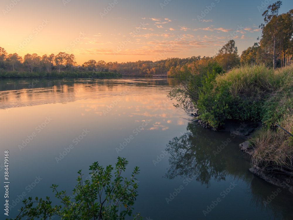 Obraz premium Beautiful Riverside Sunrise with Cloud Reflections