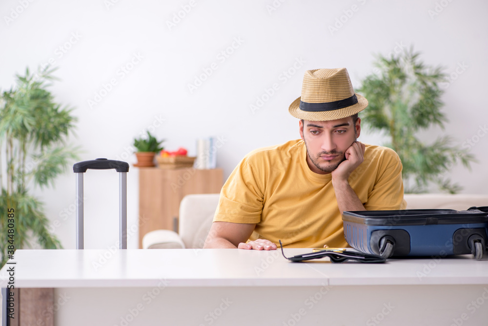 Young man preparing for journey at home Young man preparing for journey at home