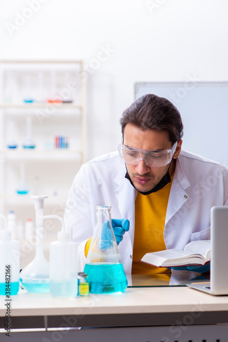 Young male chemist student preparing for exam