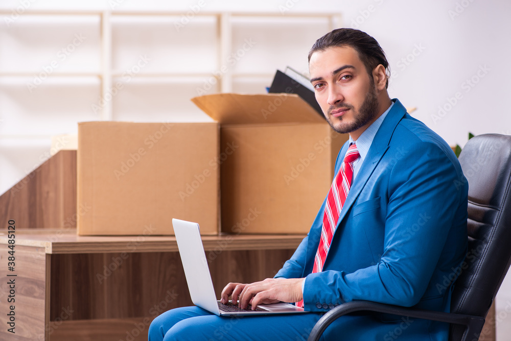 Young male employee in relocation concept Young male employee in relocation concept