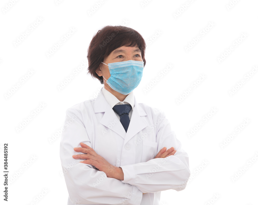 Female doctor holding arms wearing mask standing in front of white background Female doctor holding arms wearing mask standing in front of white background
