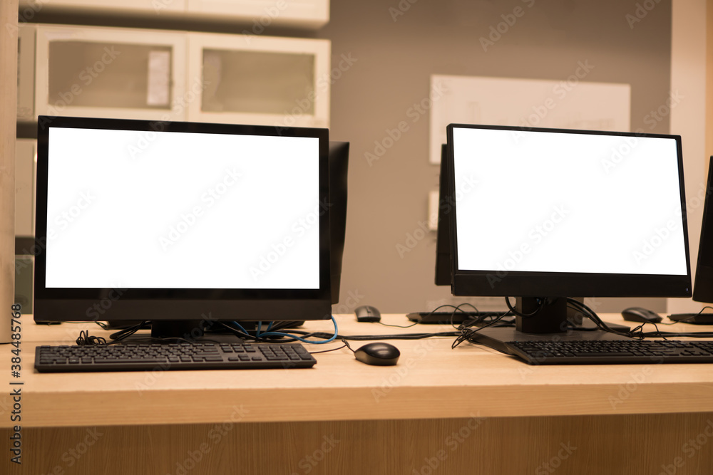 E-learning study concept: Mockup of monitor computer pc for business training computers using or typing on pc with blank white screen in information technology center at university E-learning study concept: Mockup of monitor computer pc for business training computers using or typing on pc with blank white screen in information technology center at university