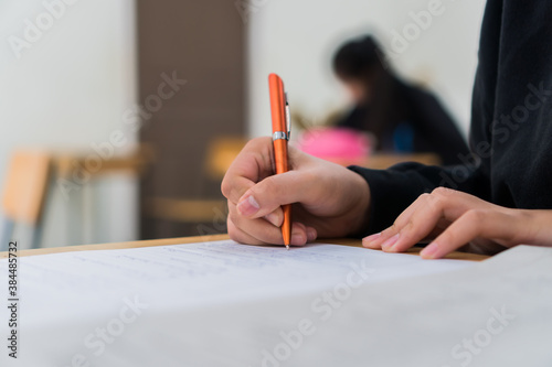 Hands Student testing in exam on exercise taking at high school or university in test room. Writing document exams at campus classroom, back to school and evaluation measurement in education