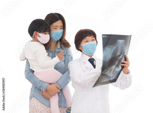 Respiratory doctor is explaining X-rays to parents and children