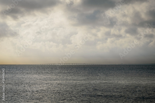 Clouds over the water of Pensacola Bay. View of distant Garcon Point bridge.