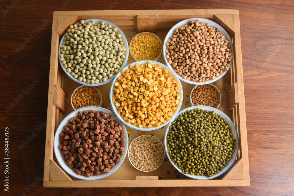 Various sources of vegetable protein beans, lentils, peas, chickpeas, mung bean in bowls. Indian Pulses uncooked , Lentils, Rice healthy balanced diet for vegans and vegetarians. Legumes assortment