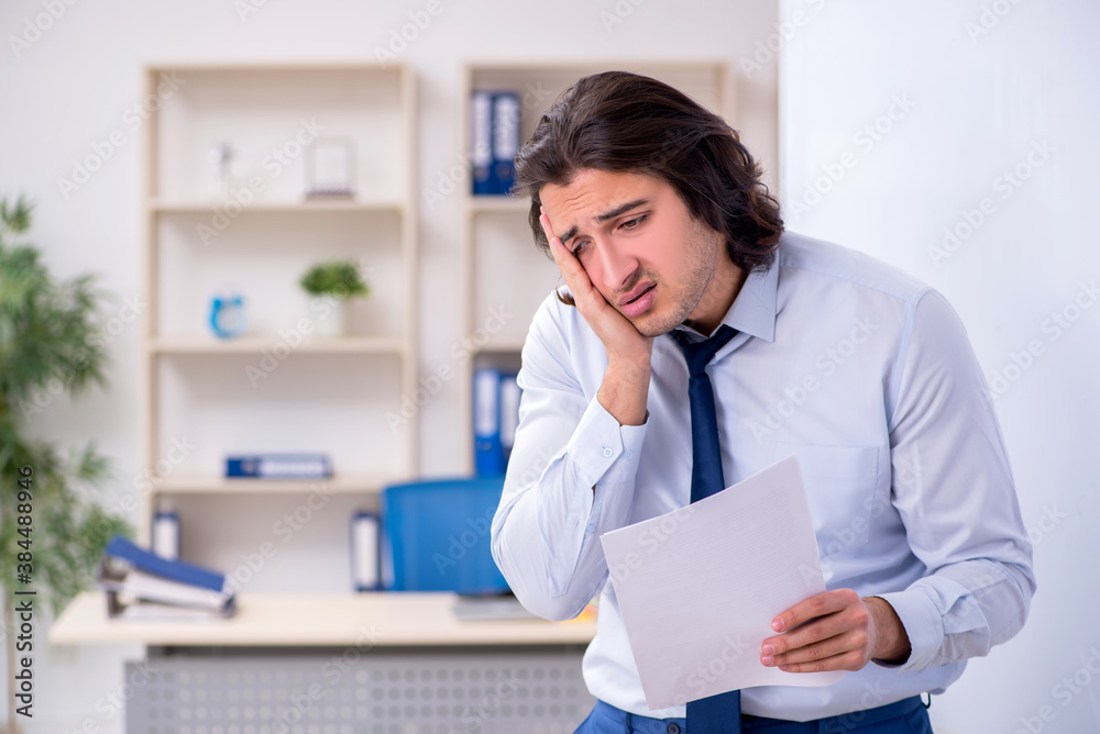 Young man employee in business presentation concept Young man employee in business presentation concept
