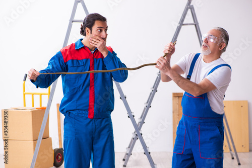 Two contractors and snake indoors