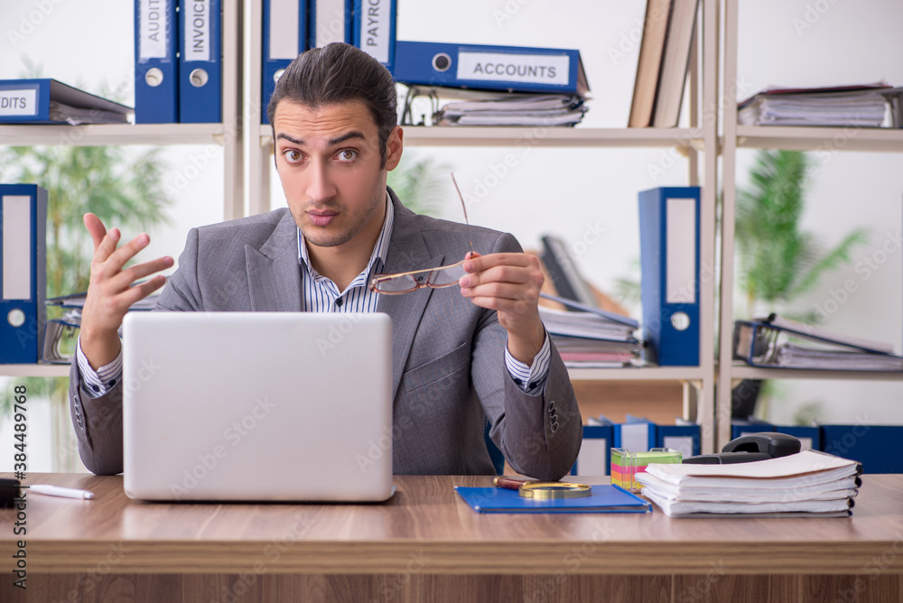 Young male employee businessman at workplace Young male employee businessman at workplace