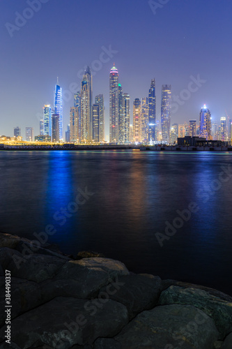Night view of Dubai Marina skyline with illuminated buildings  Modern city futuristic night view concept photo