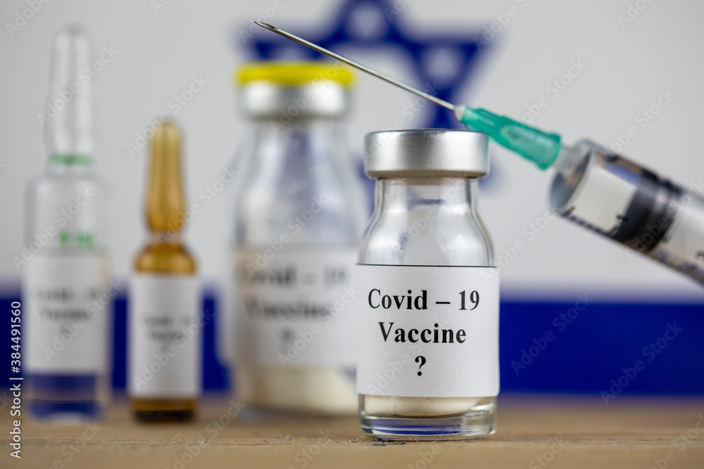 Israel Flag and bottle with vaccine and syringe, Coronavirus, Covid-19, Medicine, science and healthcare concept Israel Flag and bottle with vaccine and syringe, Coronavirus, Covid-19, Medicine, science and healthcare concept