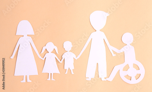 paper family cutout on yellow background.