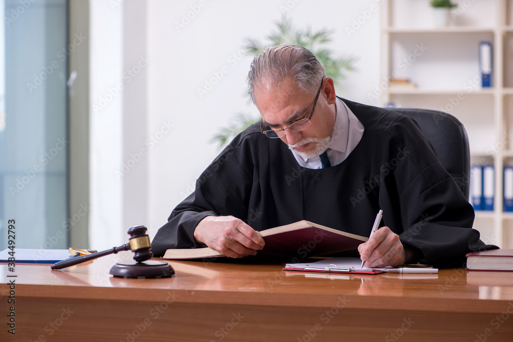 Old male judge working in courthouse Old male judge working in courthouse