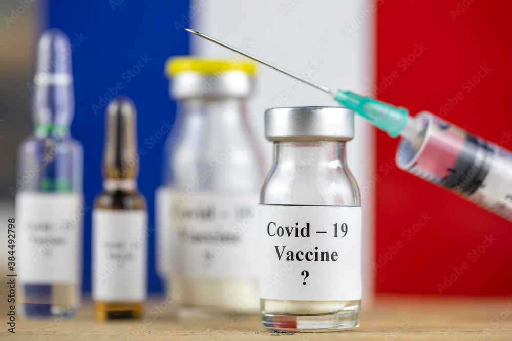 France Flag and bottle with vaccine and syringe, Coronavirus, Covid-19, Medicine, science and healthcare concept France Flag and bottle with vaccine and syringe, Coronavirus, Covid-19, Medicine, science and healthcare concept