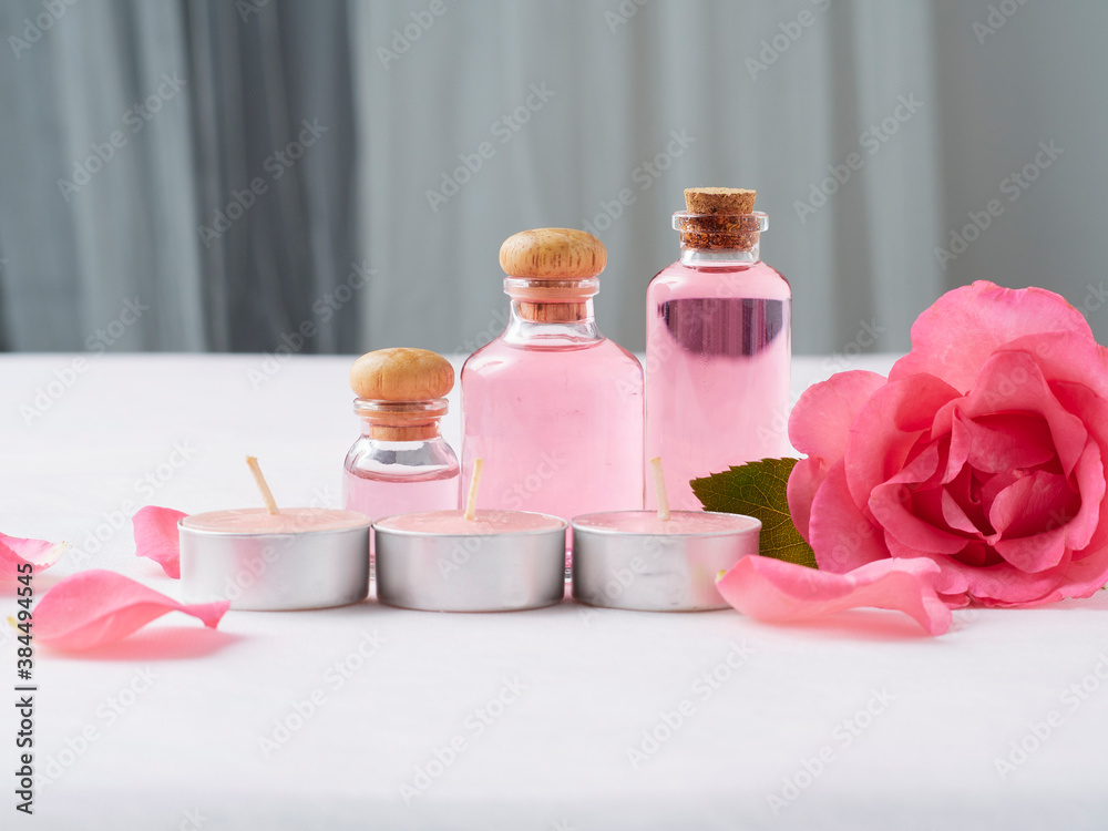 Aromatherapy oil bottles and pink rose Aromatherapy oil bottles and pink rose