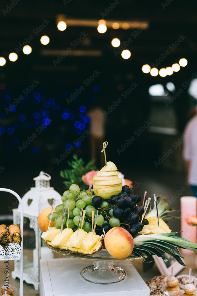 Different fresh fruits on wedding buffet table. Wedding table decoration. Buffet reception fruits.