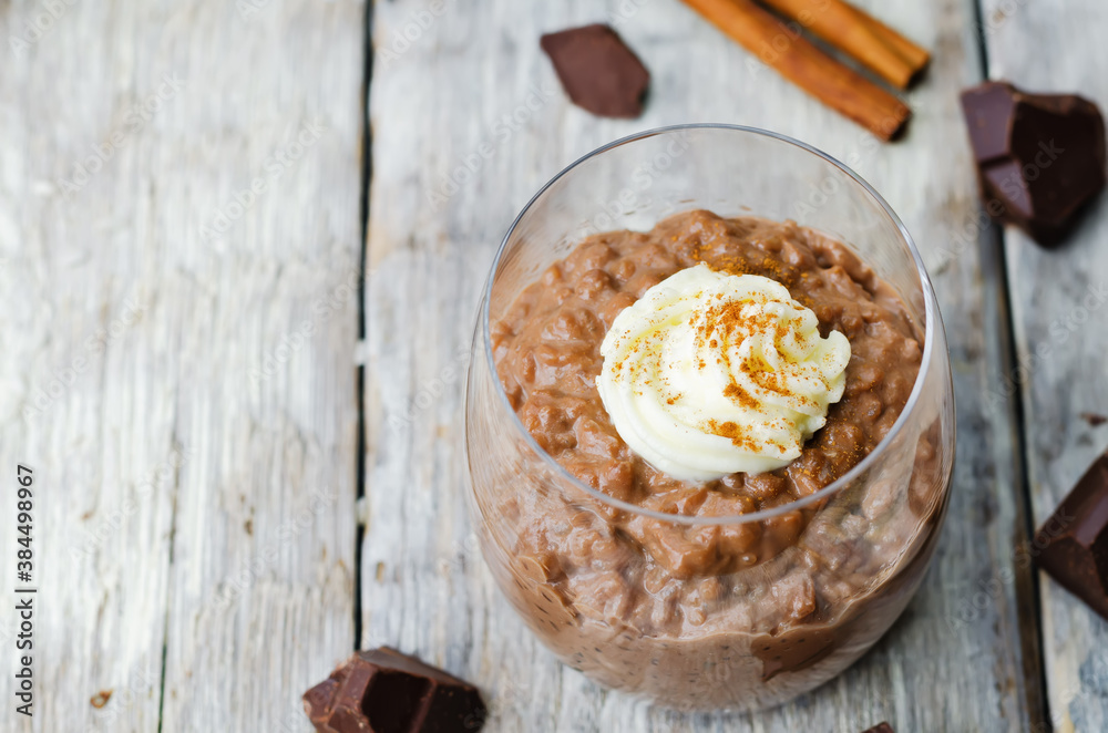 chocolate rice pudding decorated with whipped cream with cinnamon