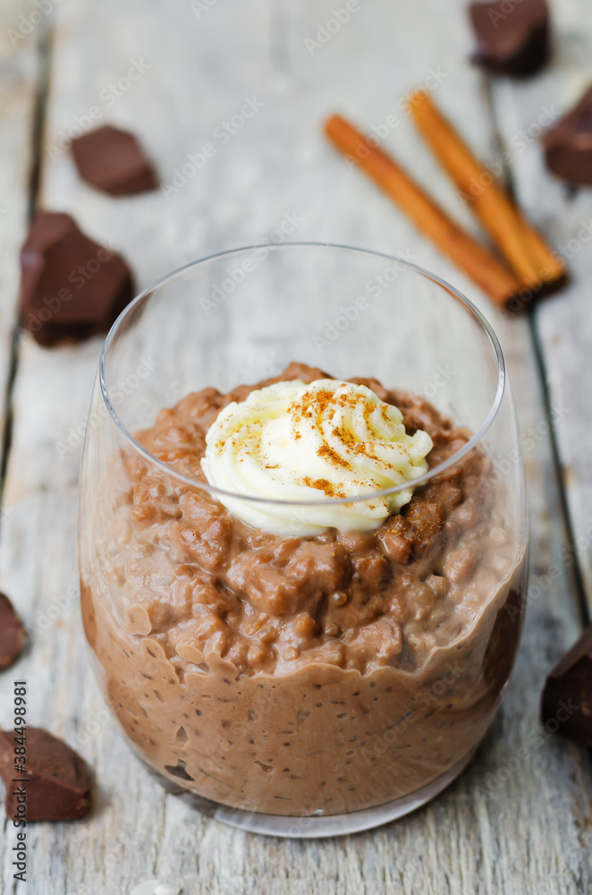 chocolate rice pudding decorated with whipped cream with cinnamon chocolate rice pudding decorated with whipped cream with cinnamon
