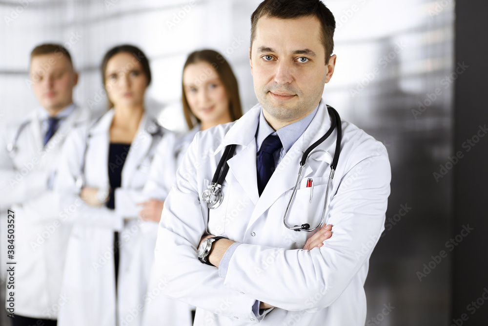 Group of professional doctors, standing as a team with crossed arms in a hospital office, ready to help their patients. Medical help, insurance in health care and medicine concept Group of professional doctors, standing as a team with crossed arms in a hospital office, ready to help their patients. Medical help, insurance in health care and medicine concept