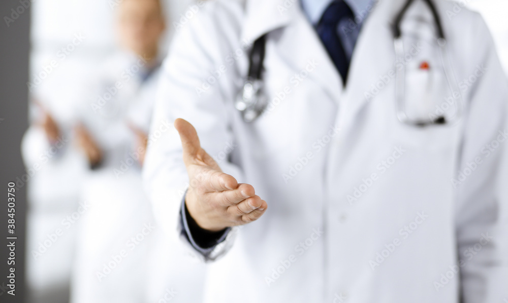 Team of unknown doctors is offering helping hand to the patients, close up. Physicians ready to help people. Medical help, insurance in health care, medicine concept Team of unknown doctors is offering helping hand to the patients, close up. Physicians ready to help people. Medical help, insurance in health care, medicine concept