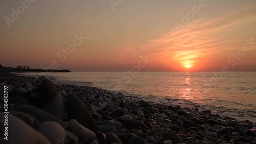 Amazing sunrise over the beach. Yellow golden sun over sea. Orange colors waves. Nature background. Beautiful scene. Morning. Sunlight reflect on water surface