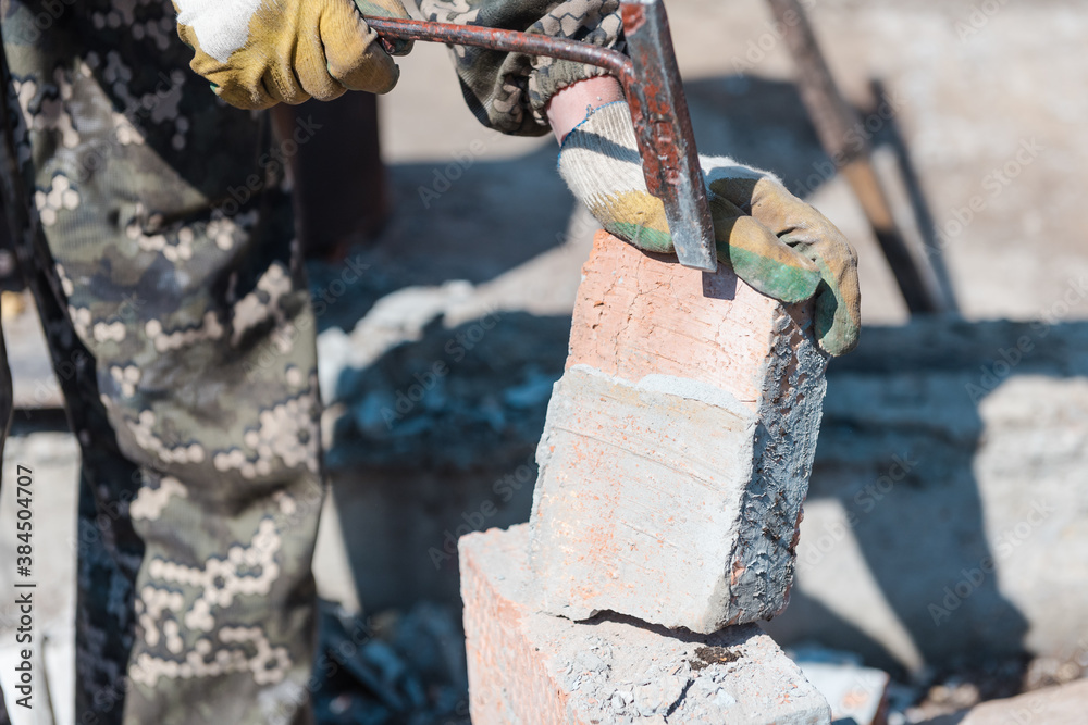 Foto de Brick in cement. Build out of bricks. Breaking down a brick