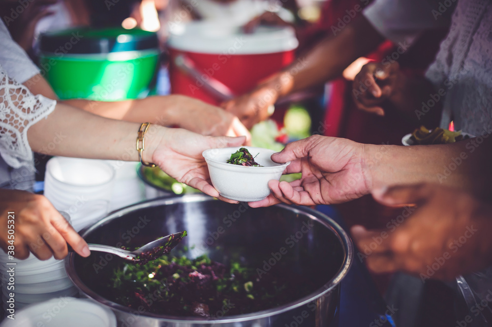 Donate food to people in society : The hands of the poor receive food from the hands of the philanthropist Donate food to people in society : The hands of the poor receive food from the hands of the philanthropist