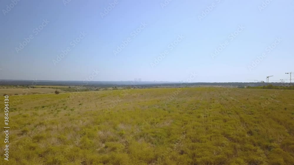 different shots of the skyline of a large European city from the fields of its periphery.Madrid